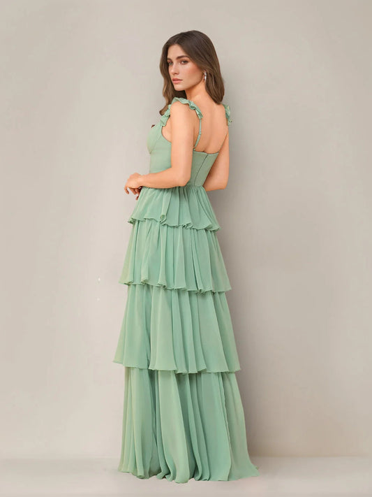 Mint green tiered ruffled sleeveless maxi dress shown from the side, with side slit