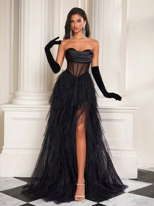 Black strapless corset prom dress with tiered tulle skirt and front slit, long sheer gloves