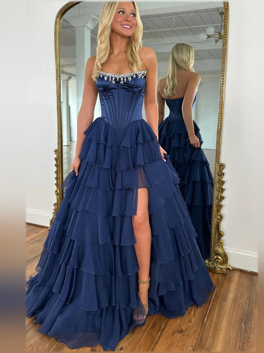 Dark navy strapless formal dress with tiered ruffle A-line skirt and slit detail