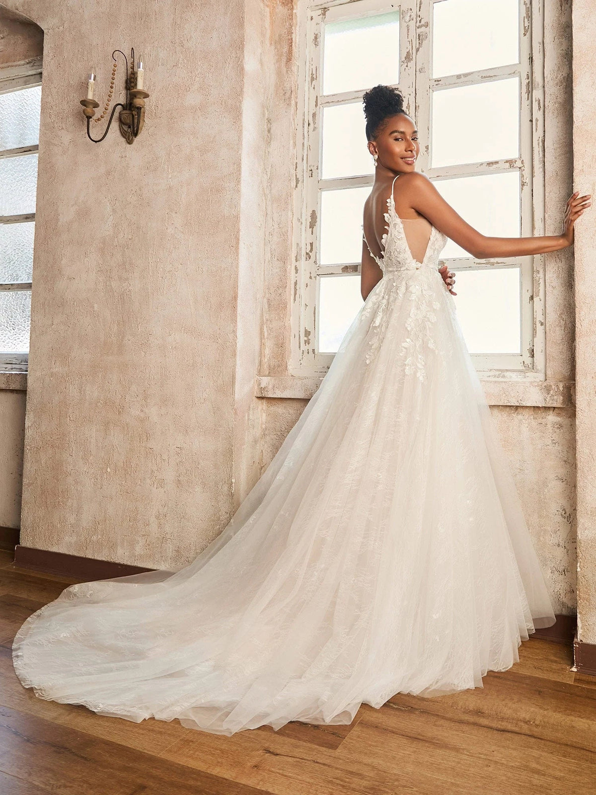 Ivory sleeveless V-neck A-line wedding dress with lace appliques and layered tulle skirt