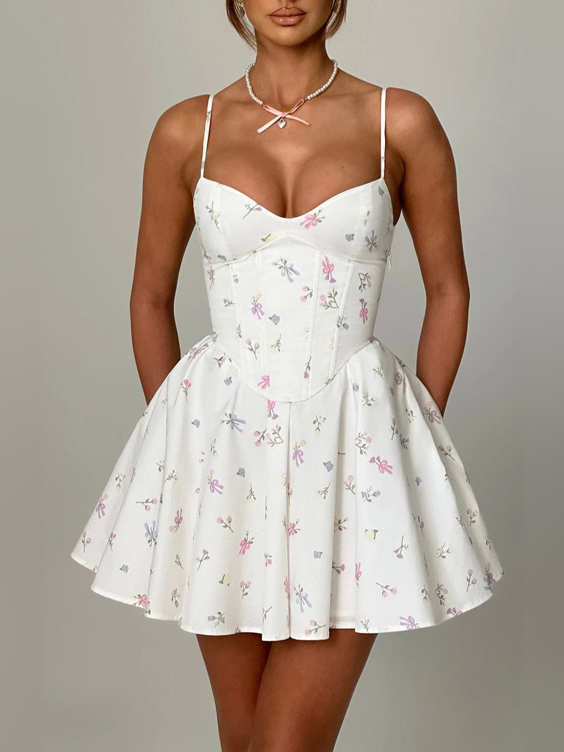 Floral mini homecoming dress with spaghetti straps, sweetheart neckline, and flared skirt
