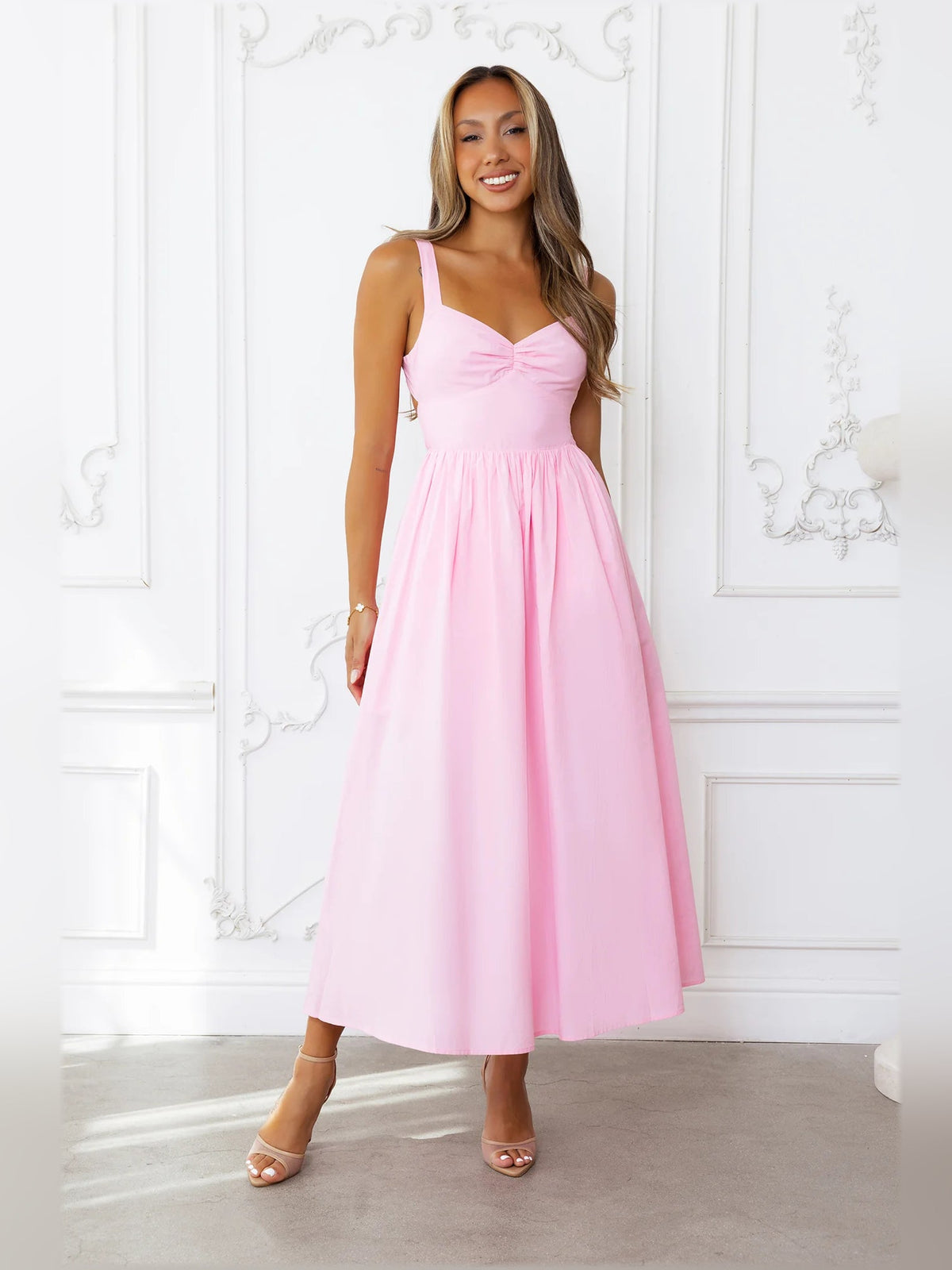 Pink midi formal dress with bow bodice and spaghetti straps, gathered waist
