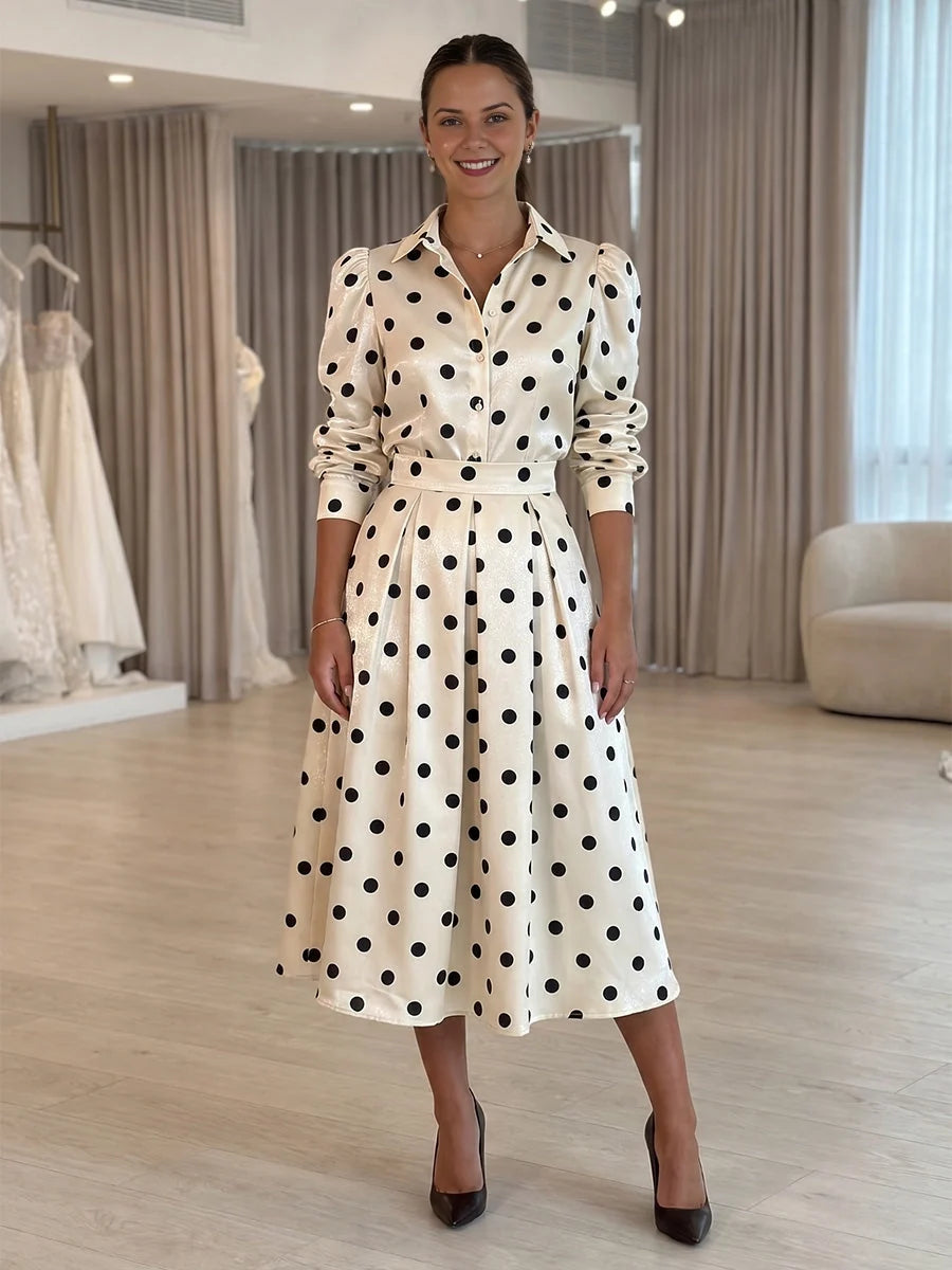 White satin midi dress with black polka dots, V-neck, long sleeves, belted A-line flare