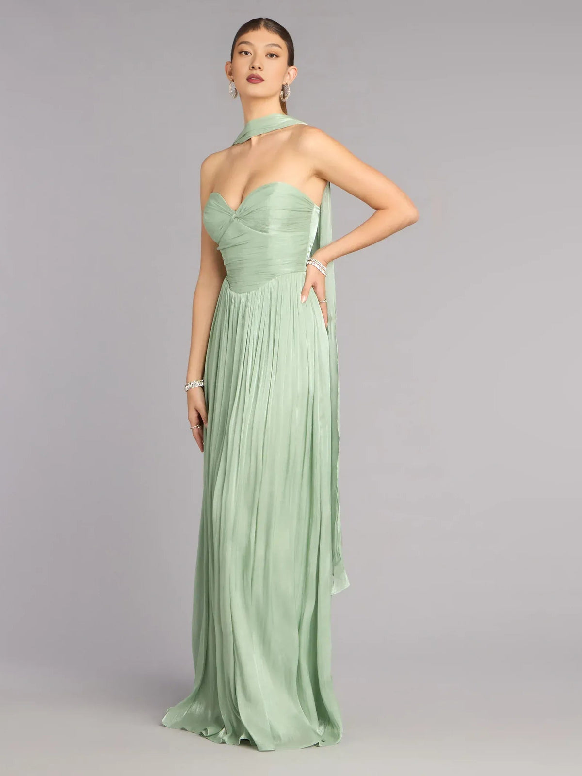 Sage green sweetheart A-line prom dress with ruched bodice and pleated floor skirt