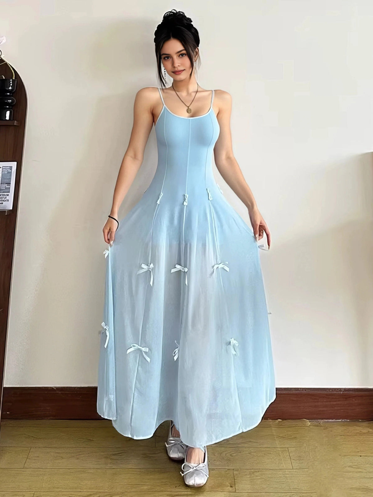 Light blue A-line maxi prom dress with scoop neck and spaghetti straps, bow appliques