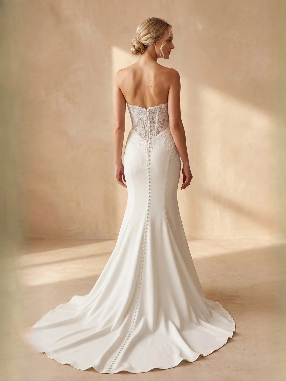 Ivory strapless lace corset wedding dress with draped back and mermaid train