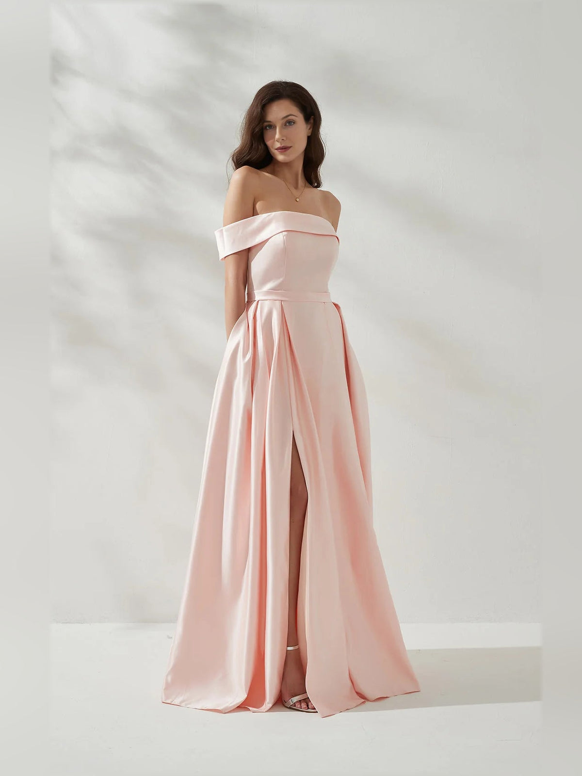 Peach off-shoulder formal dress with open back, fitted bodice and thigh slit, floor-length