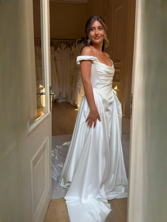 Ivory satin A-line wedding dress with draped corset and off-shoulder cowl neckline
