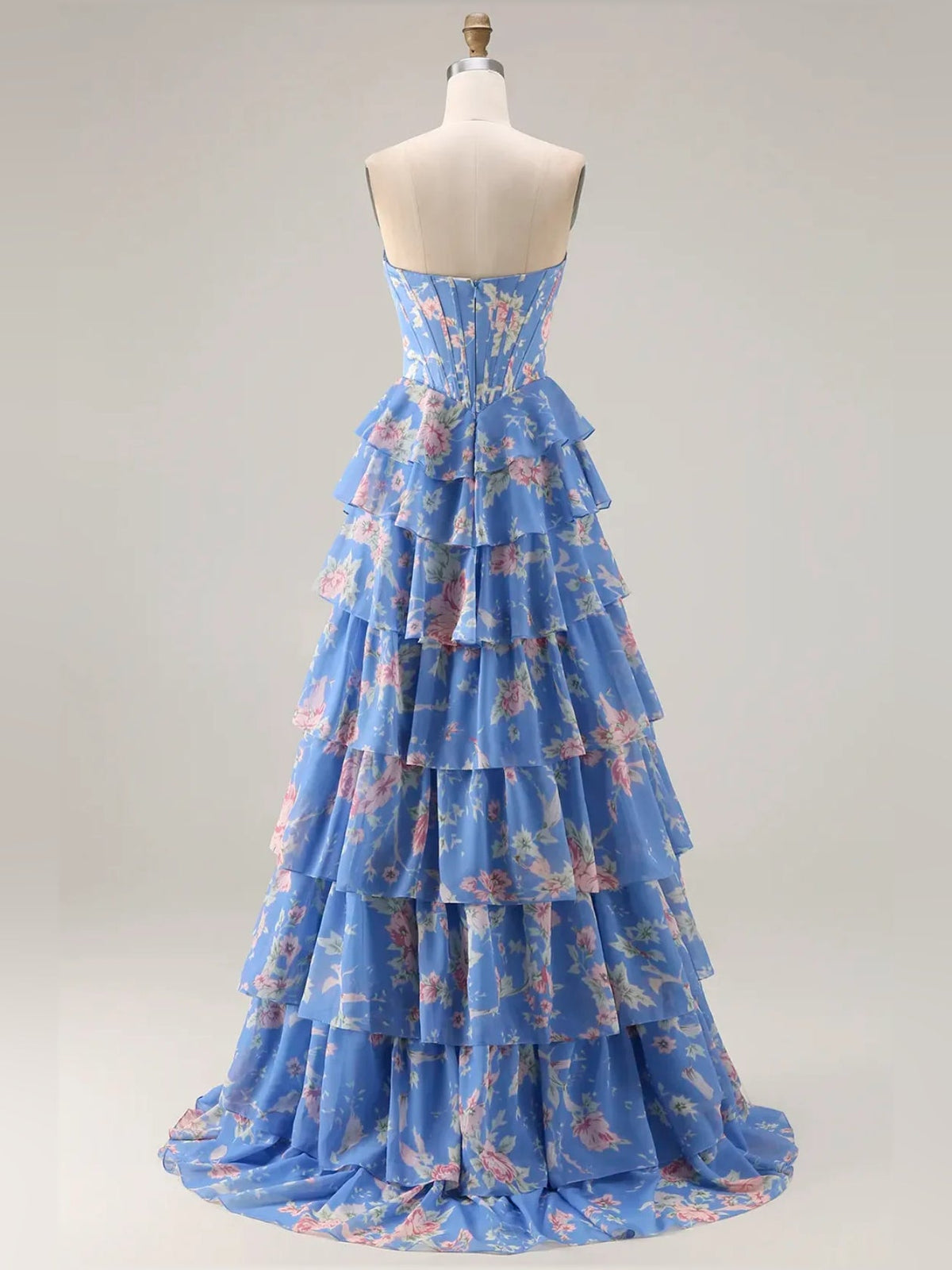 Blue floral tiered ruffle strapless A-line prom dress on a mannequin with full skirt.