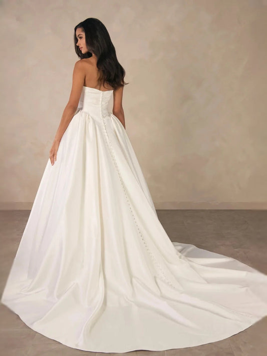 Ivory strapless A-line satin wedding dress with ruched bodice and full floor-length skirt