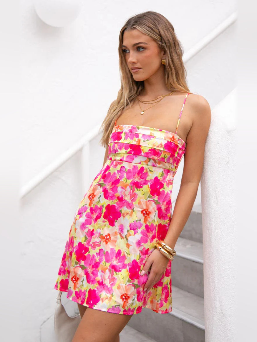 Pink and yellow floral mini dress with thin spaghetti straps and ruffled bust detail