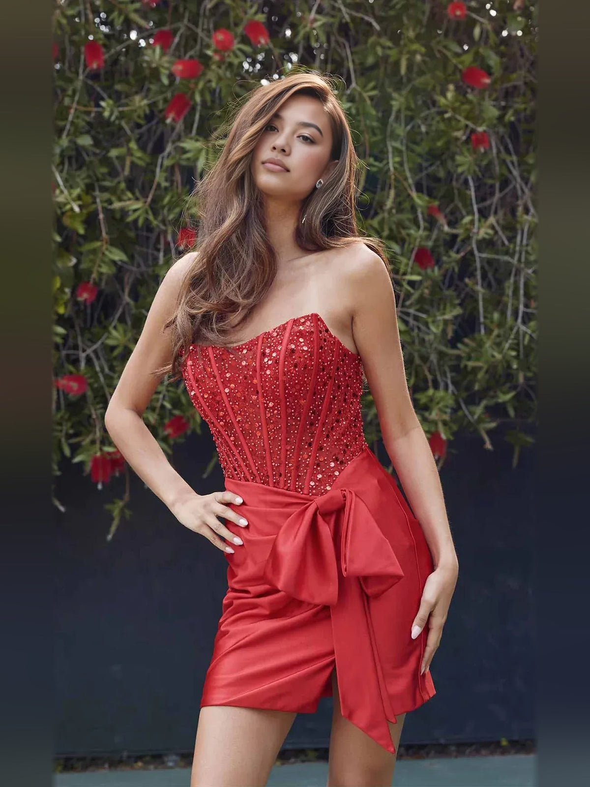 Crimson red strapless satin mini dress with ruched bodice and draped bow detail