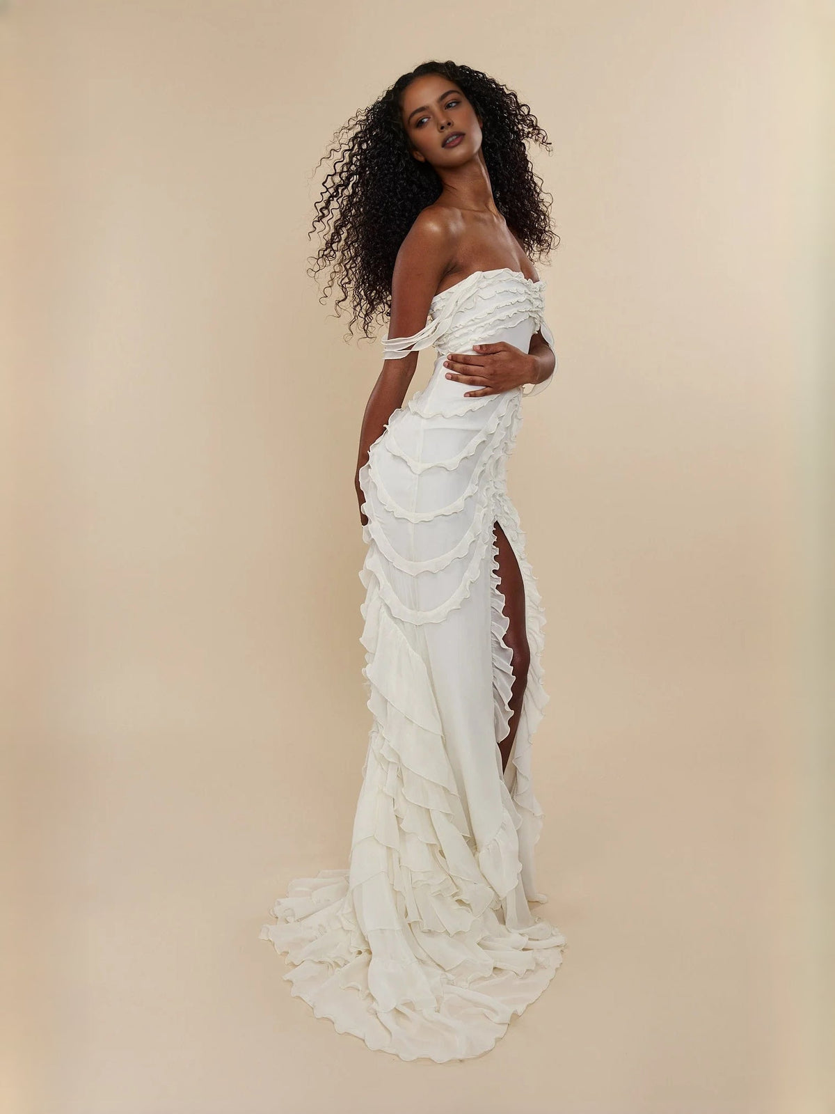 Ivory sweetheart prom dress with layered ruffles, off-shoulder straps, and thigh slit