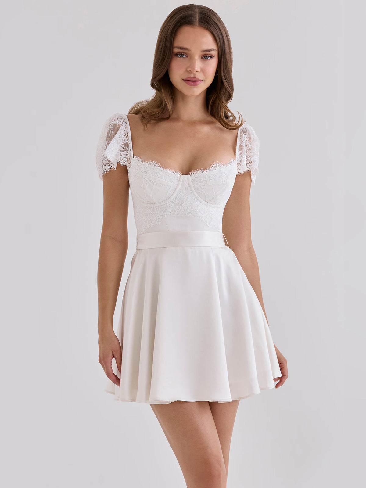 White mini satin homecoming dress with lace cap sleeves and sweetheart neckline