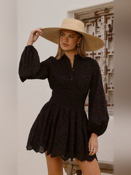 Black long-sleeve mini dress with button placket, puff sleeves, smocked waist, scalloped hem