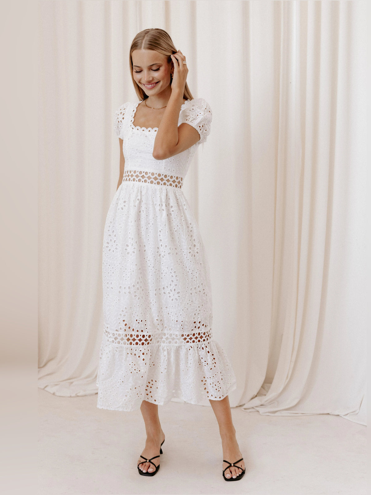 White midi formal dress with scalloped eyelet bodice, puff sleeves, and tiered skirt