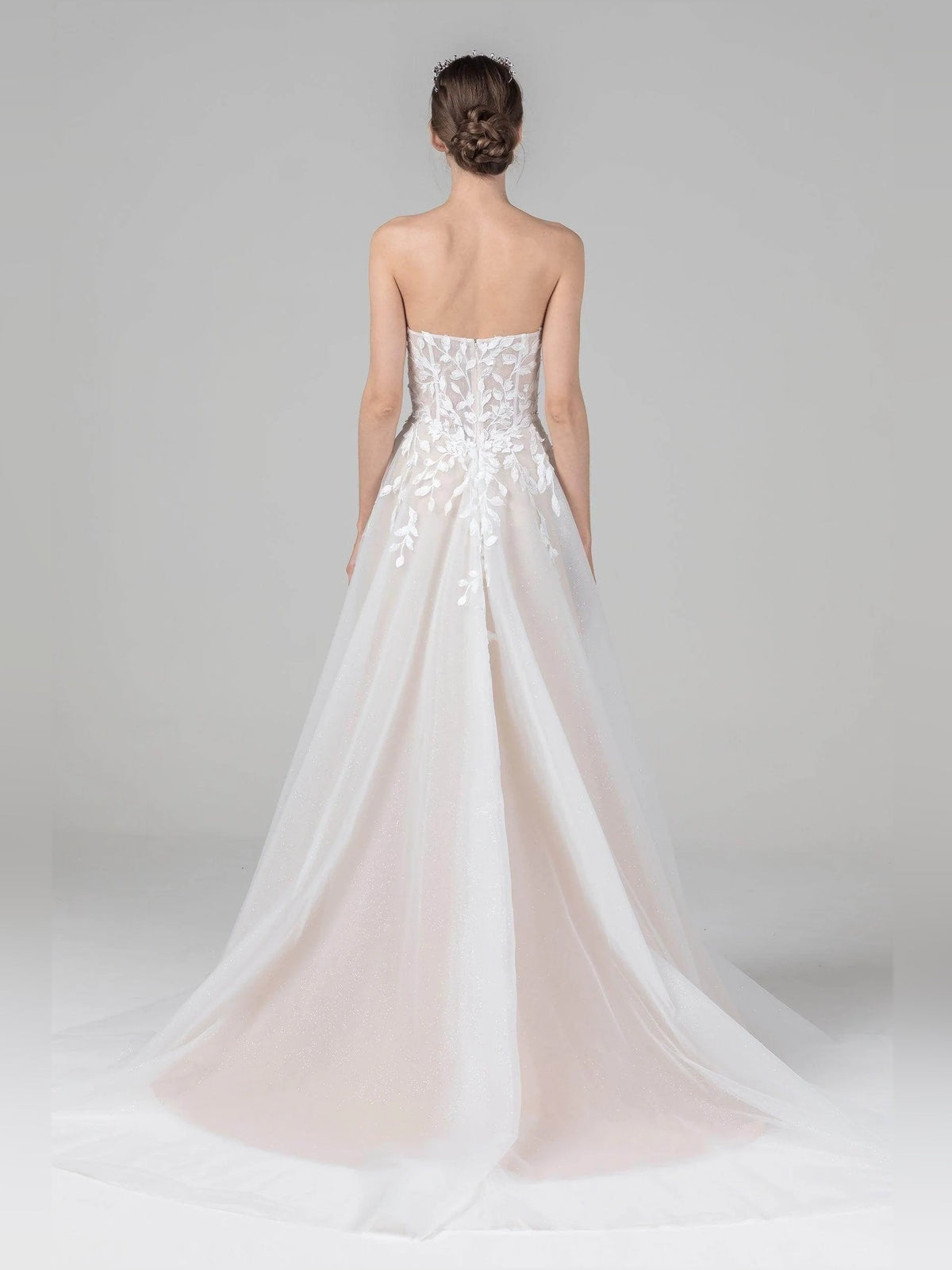 Ivory strapless A-line wedding dress with lace bodice and flowing tulle skirt, back view