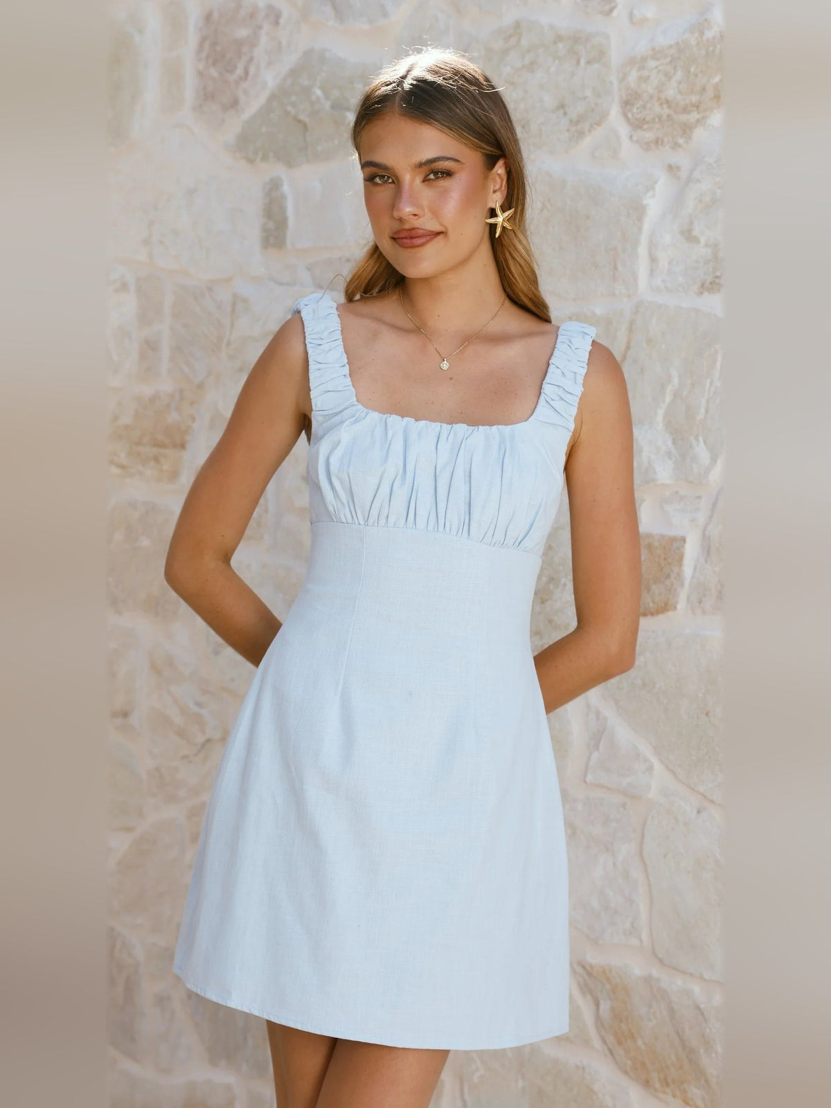 Light blue mini homecoming dress with square neckline, ruched bodice, puff straps