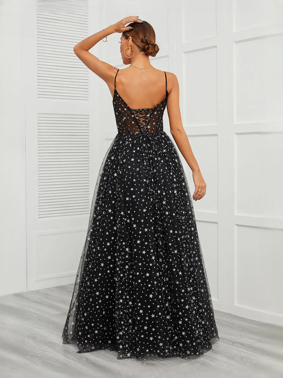 Black corset prom dress with starry tulle A-line maxi skirt, open-back straps.