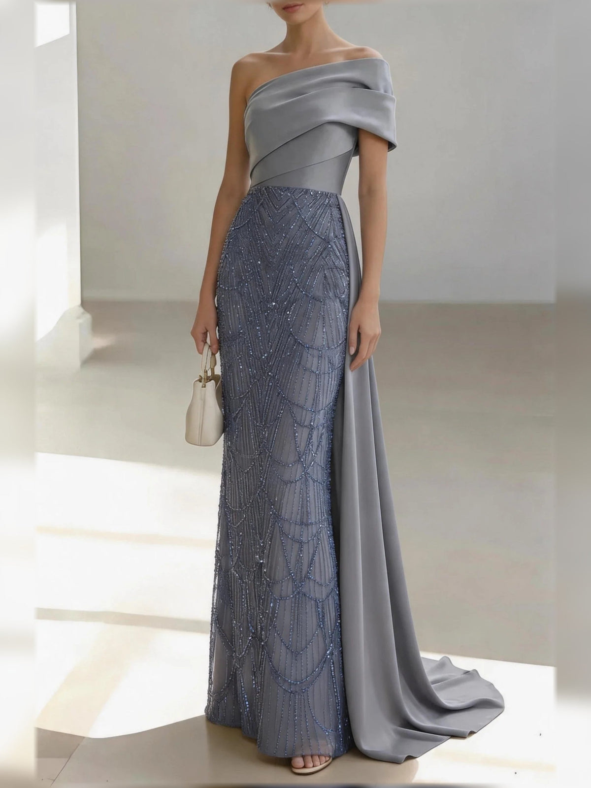 Silver one-shoulder satin mermaid gown with draped bow detail and beaded lace skirt