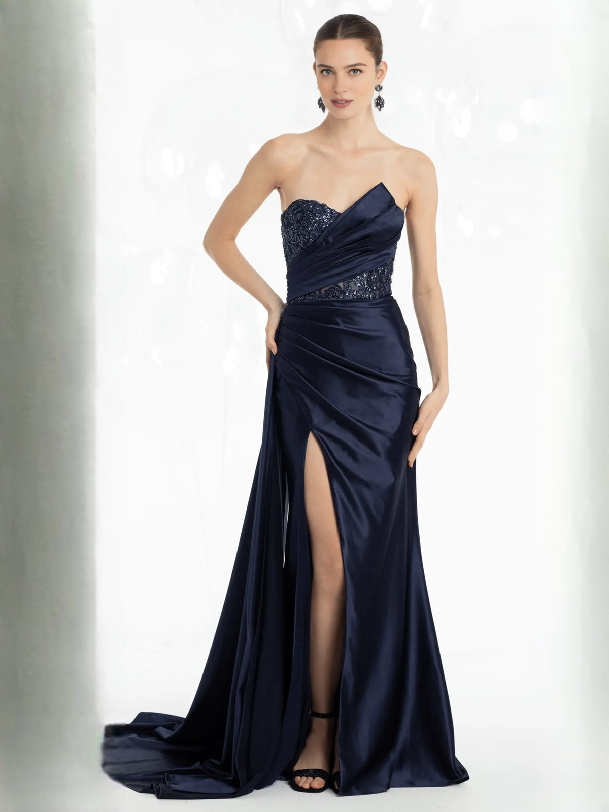 Dark navy strapless formal dress with beaded sweetheart bodice and draped skirt slit