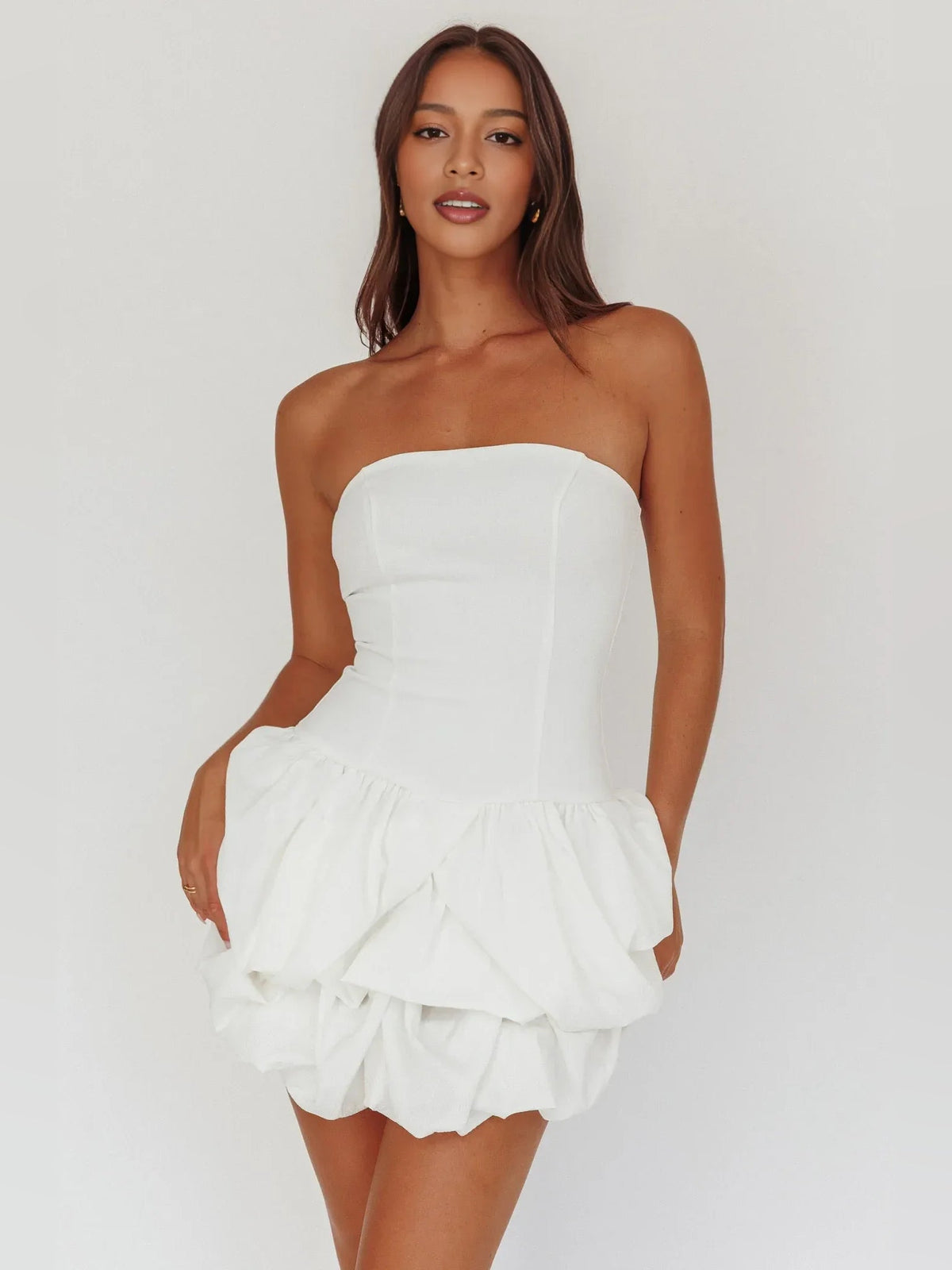 White strapless corset mini dress with tiered ruffle hem, fit-and-flare silhouette