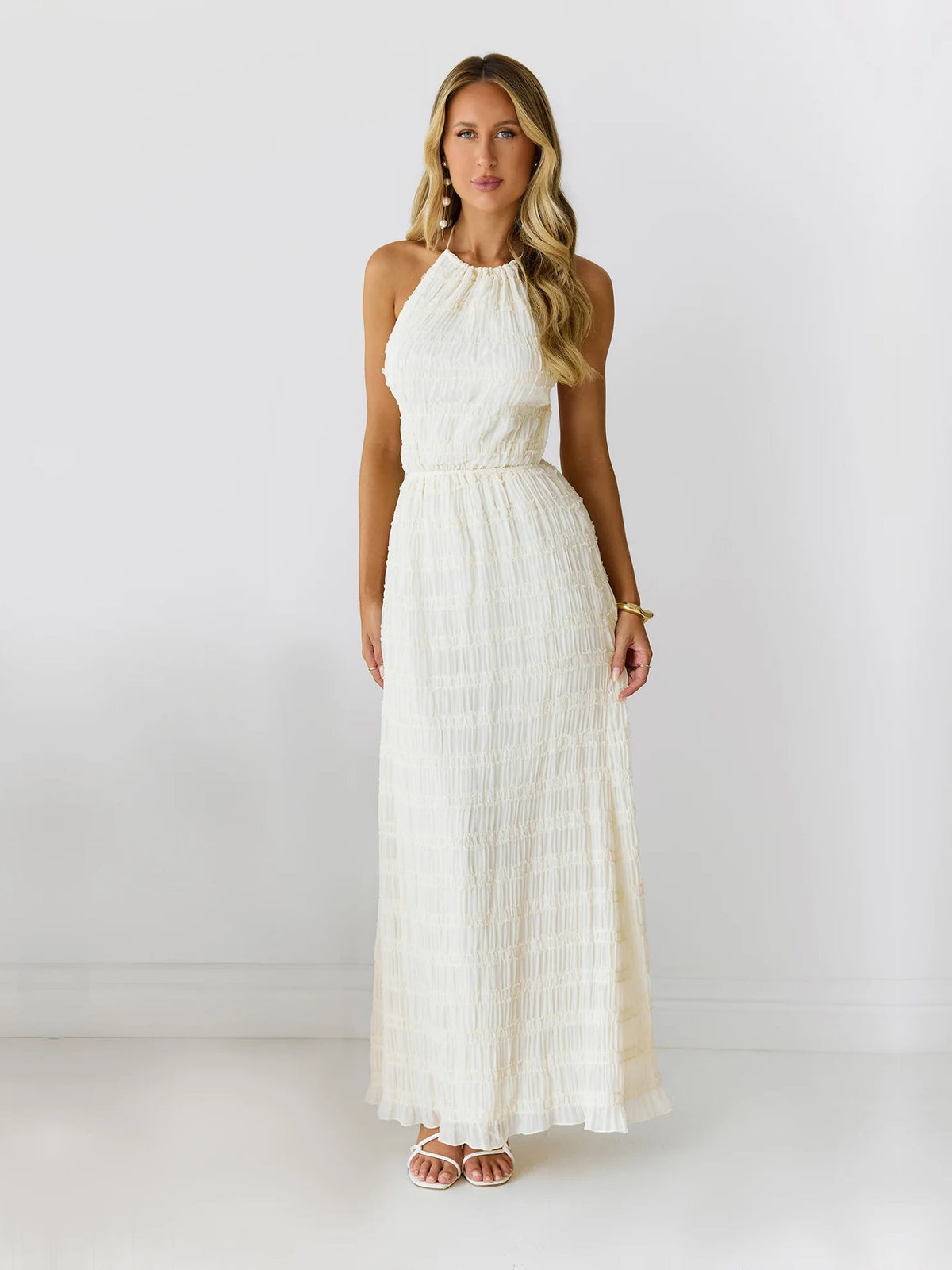 Cream a-line maxi formal dress with halter neckline, full-length front view