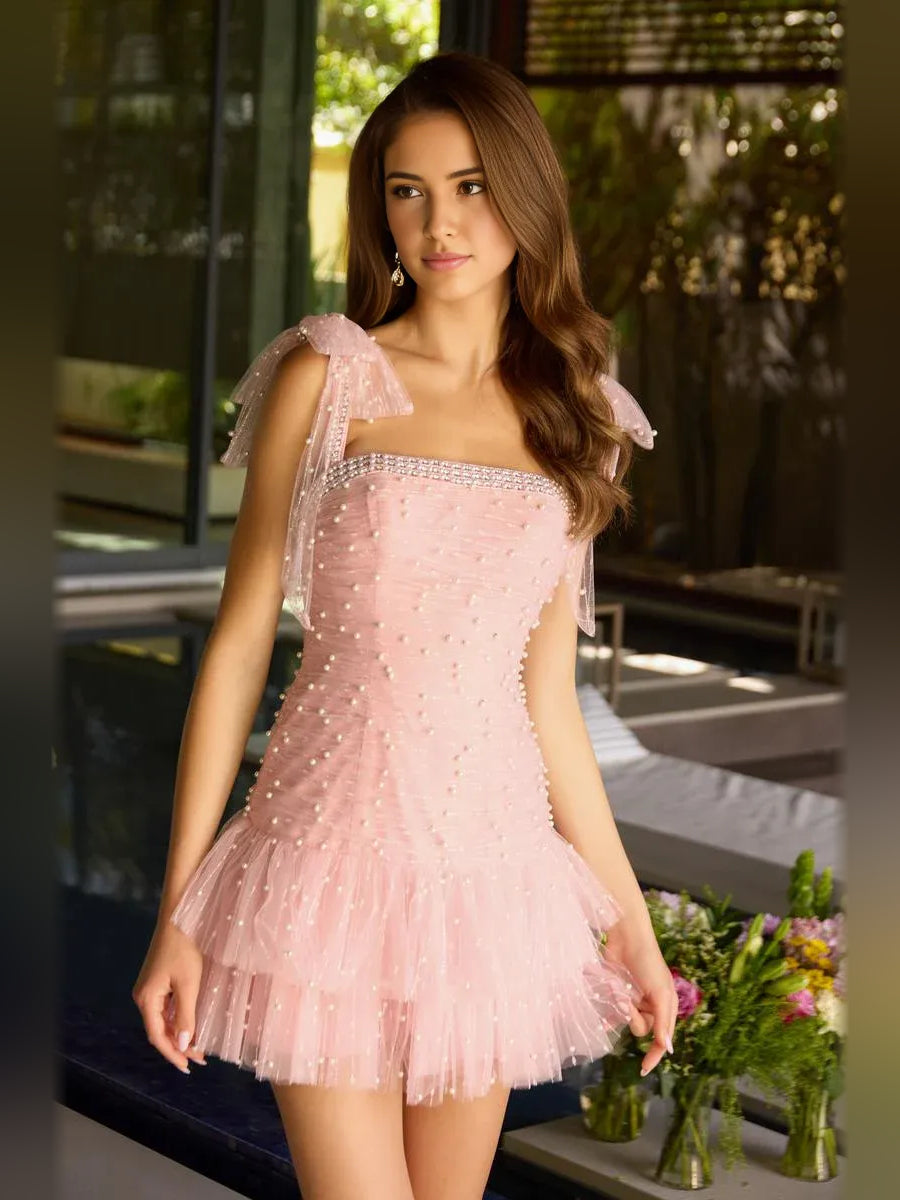 Blush pink mini tulle homecoming dress with straight neckline and tiered ruffle skirt