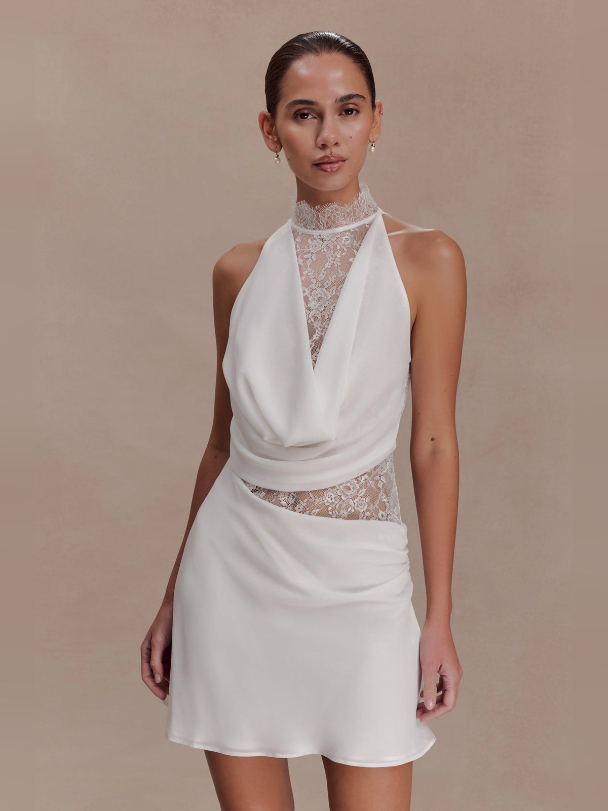 White halter-neck mini dress with chiffon drape and lace-trim sheer bodice