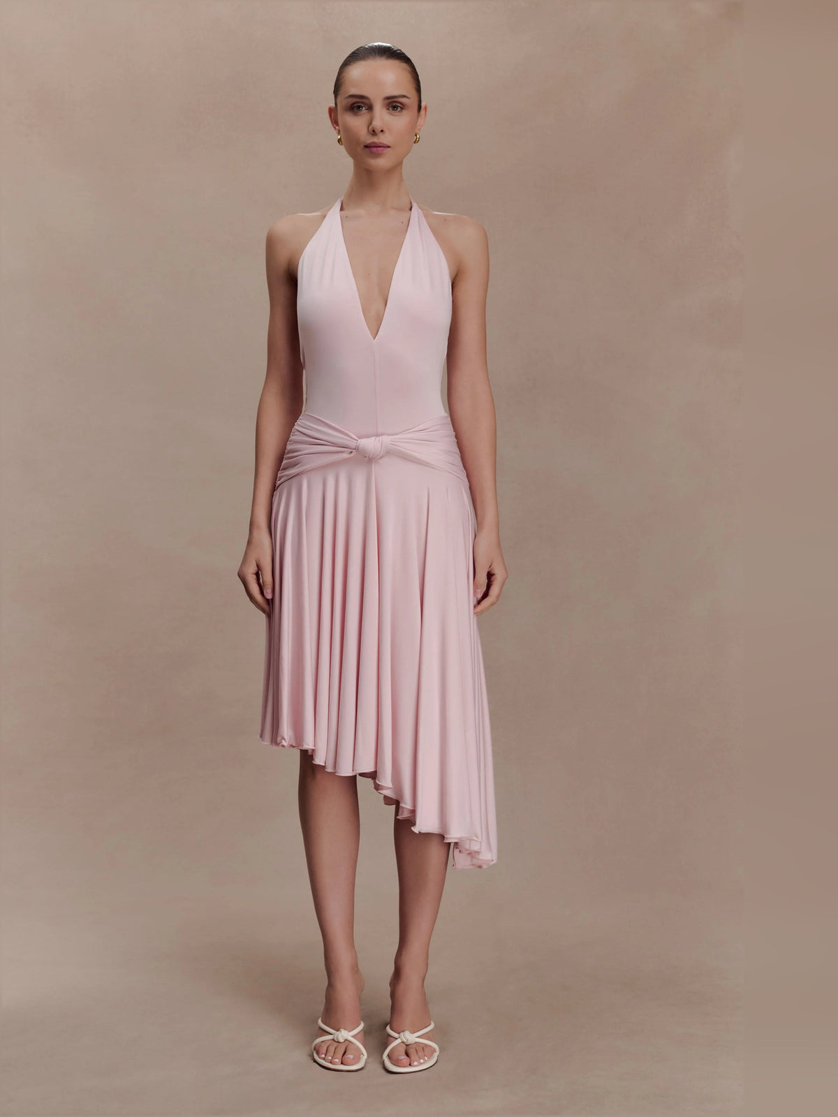 Pink asymmetric halter midi dress with draped waist knot and pleated skirt