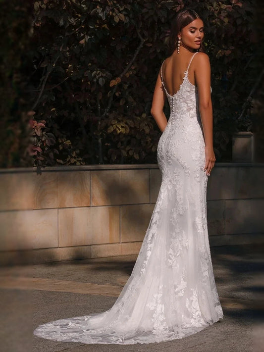 White lace mermaid wedding dress with V-neck, floral appliques, and layered tulle skirt