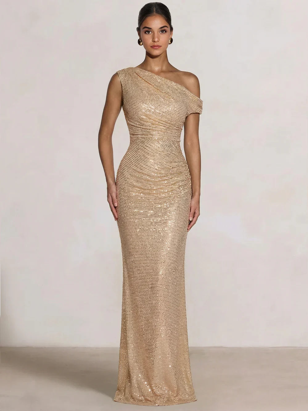 Champagne one-shoulder sequin mermaid gown with ruching, floor-length silhouette.