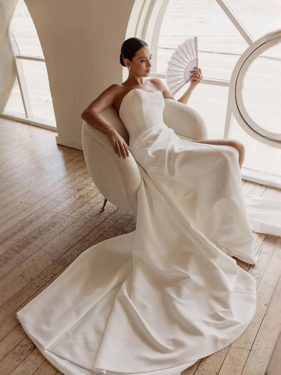 Ivory satin strapless sweetheart corset ballgown with flowing drape and full skirt