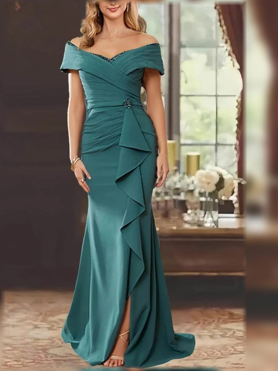 Teal off-shoulder mermaid gown with draped ruching, ruffled tiers, and side slit.
