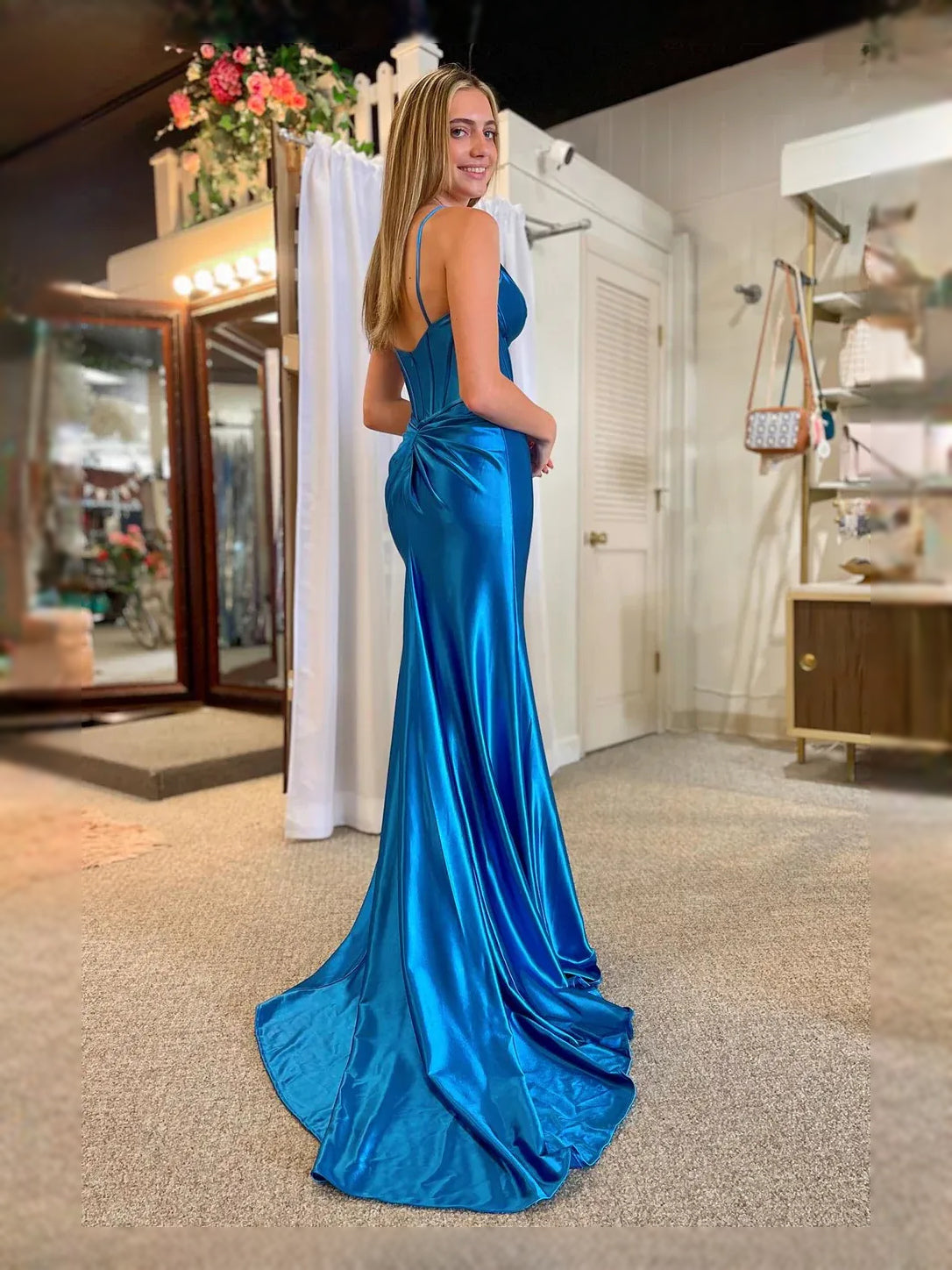 Blue satin mermaid prom dress with V-neck, spaghetti straps, and high front slit