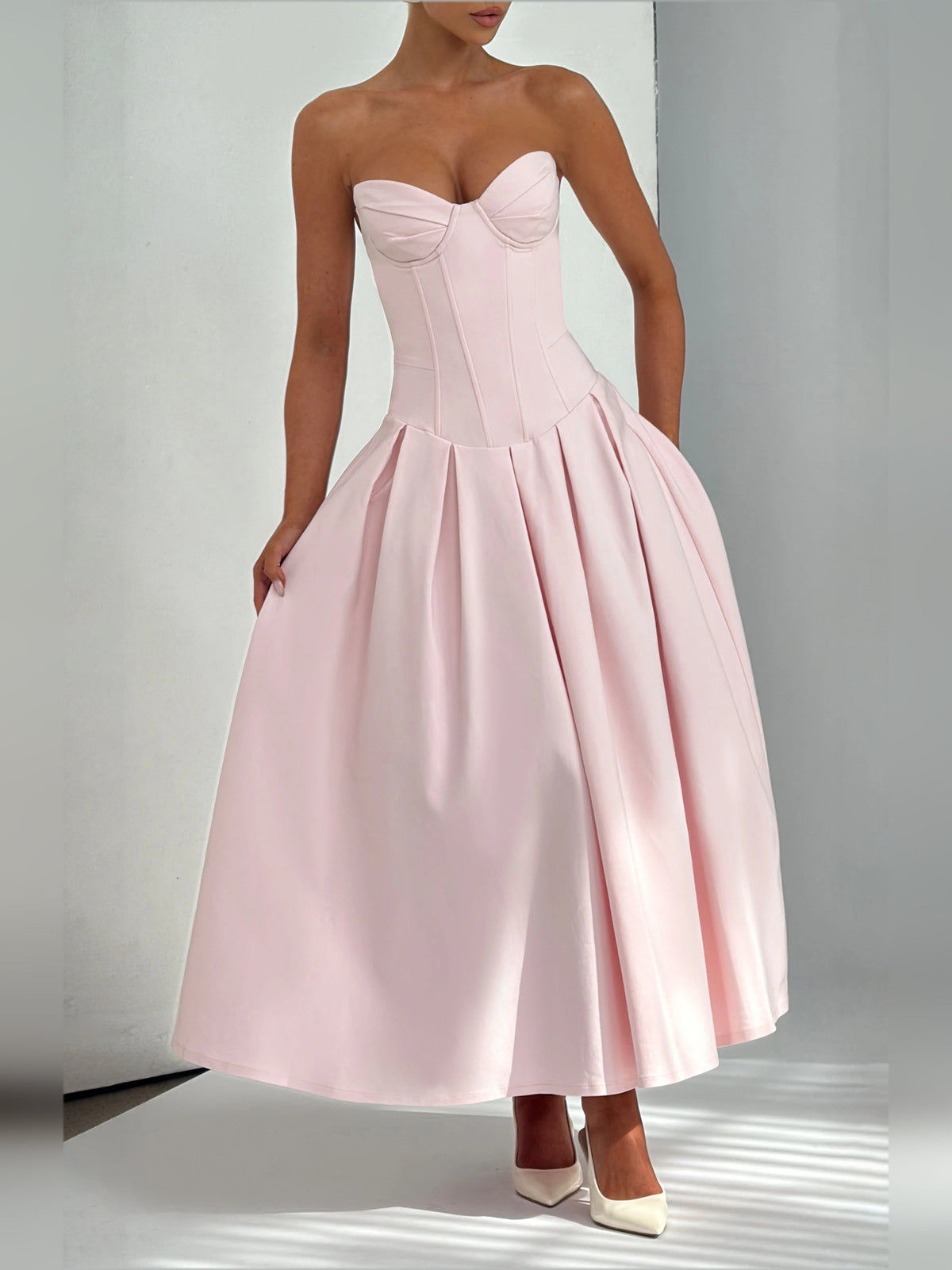 Blush pink strapless midi formal dress with sweetheart bodice and pleated skirt