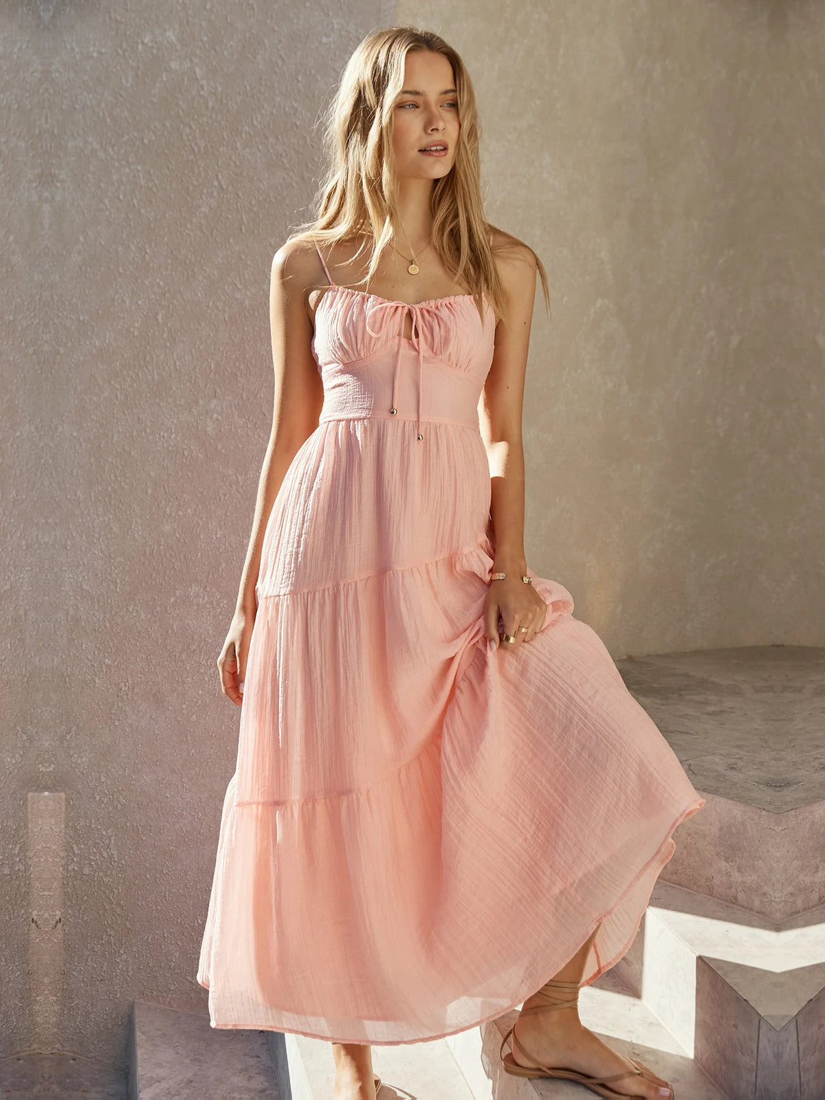 Pink a-line maxi formal dress with tiered skirt, full-length front view