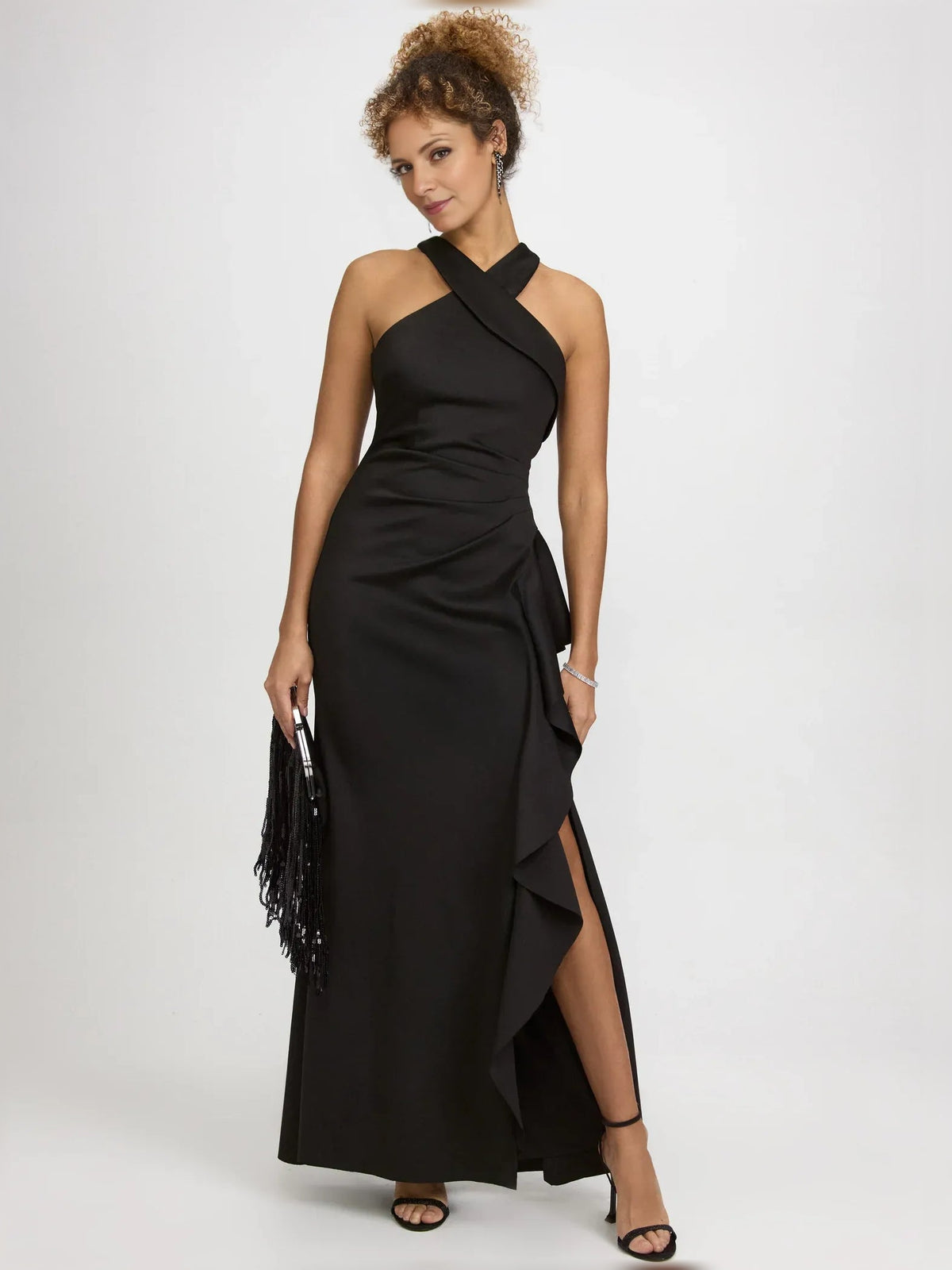 Black halter-neck formal dress with ruffled overlay and side slit, floor-length