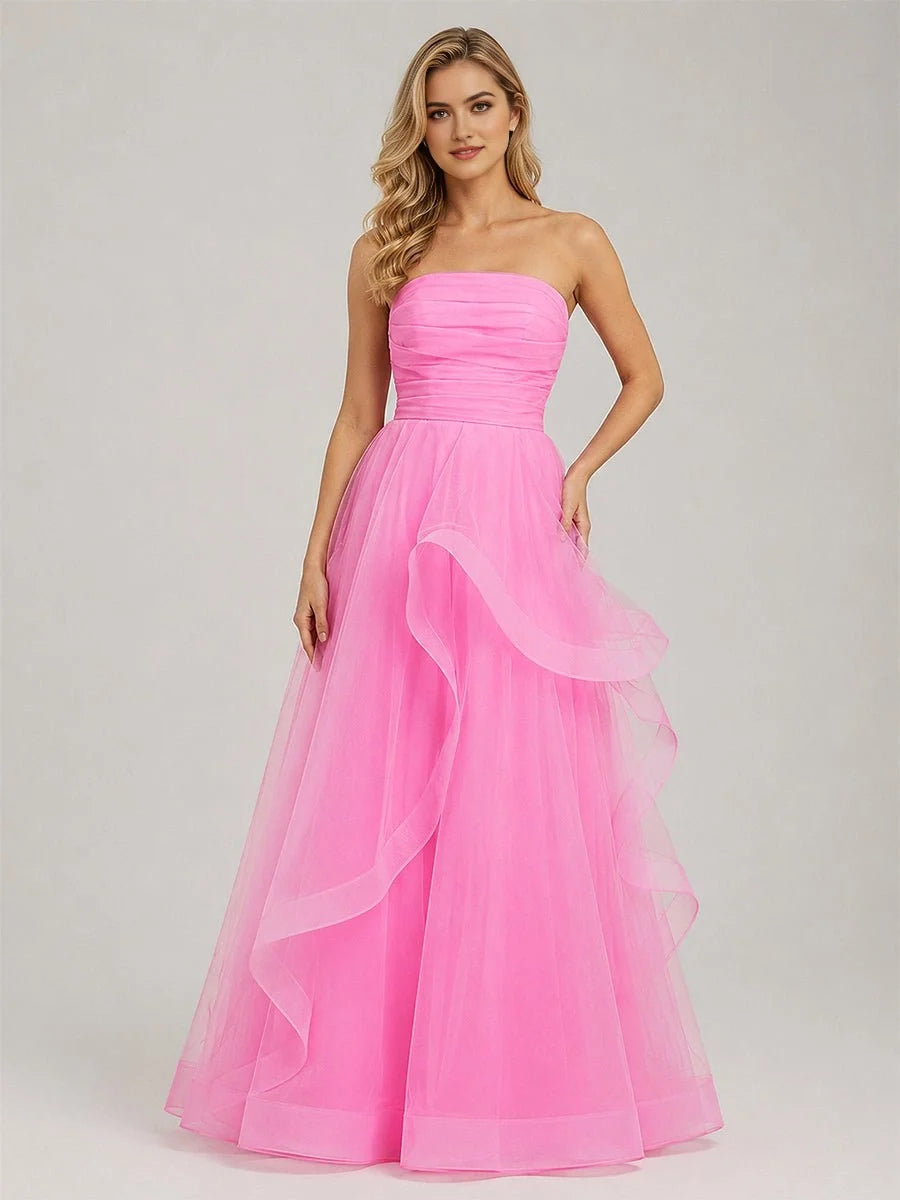 Light pink strapless tulle prom dress with ruched bodice and layered ruffle skirt