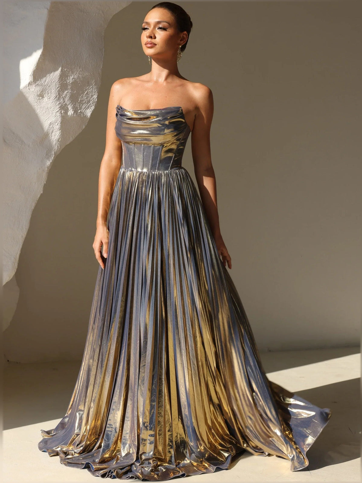 Gold metallic strapless corset dress with pleated striped floor-length skirt