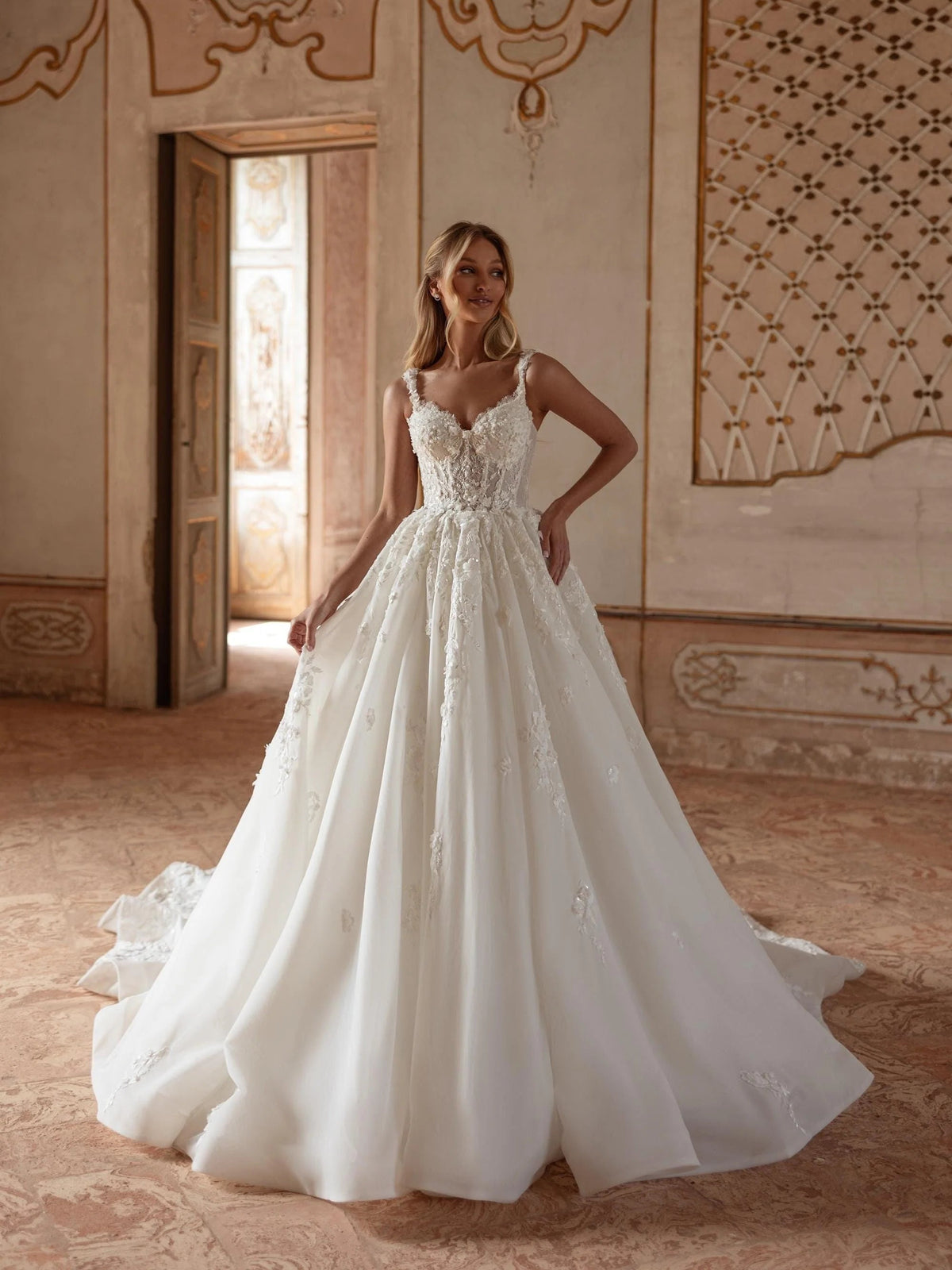 Ivory V-neck corset-style ball gown with layered floral applique and full skirt, floor-length