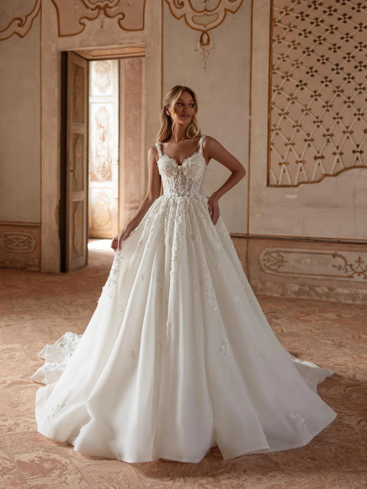 Ivory V-neck corset-style ball gown with layered floral applique and full skirt, floor-length