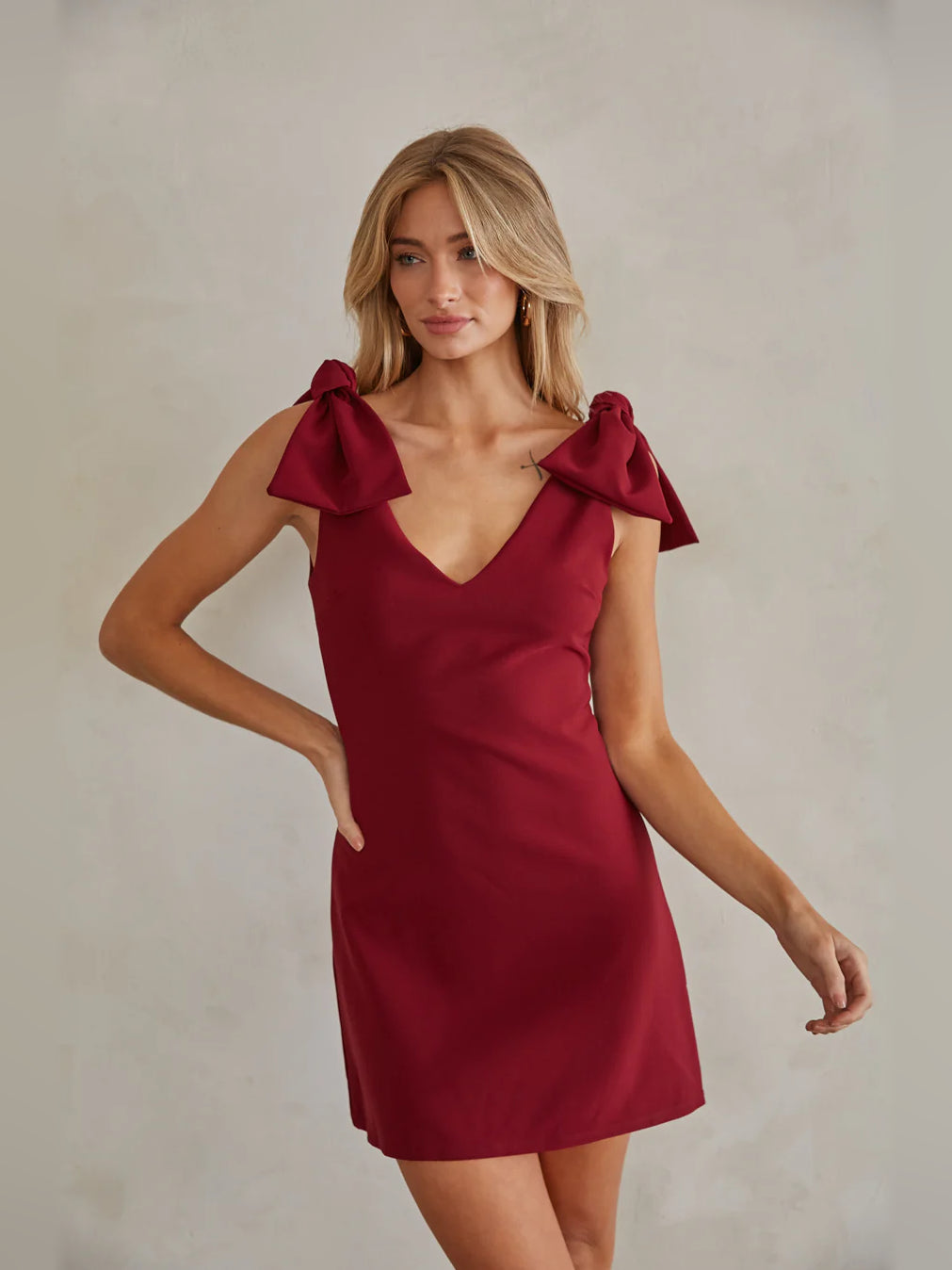 Red mini dress with V-neck and oversized bow cap sleeves