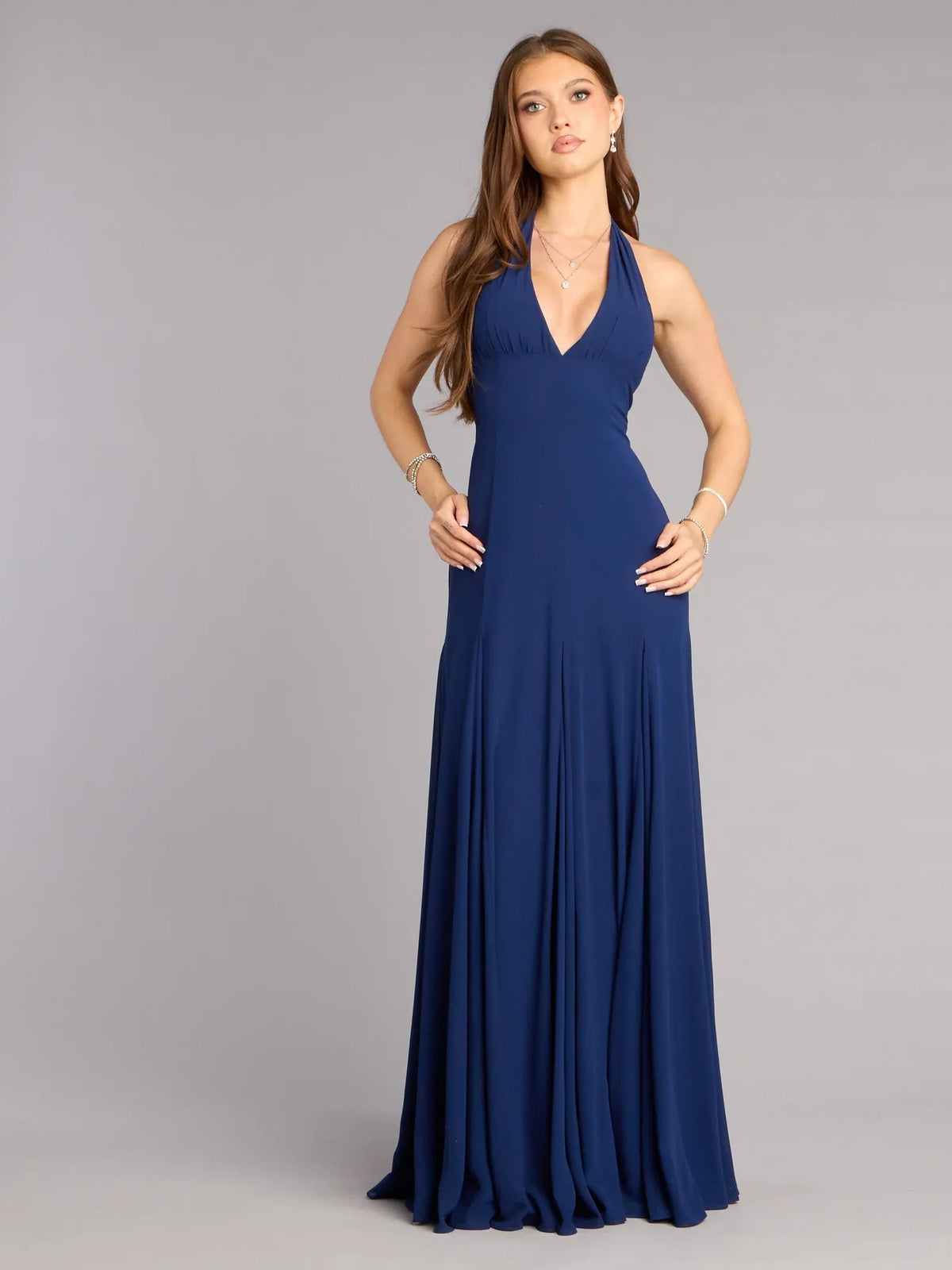 Dark navy halter open-back A-line formal dress with flowing pleated skirt