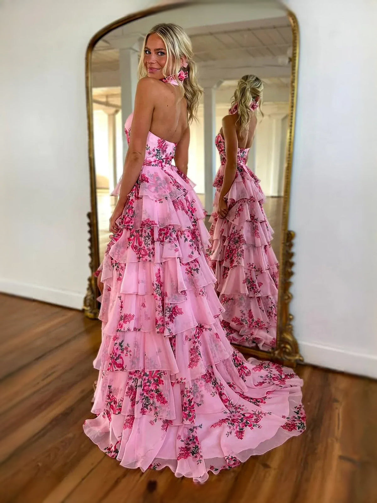 Pink floral tiered halter prom dress with front slit and flowing chiffon skirt