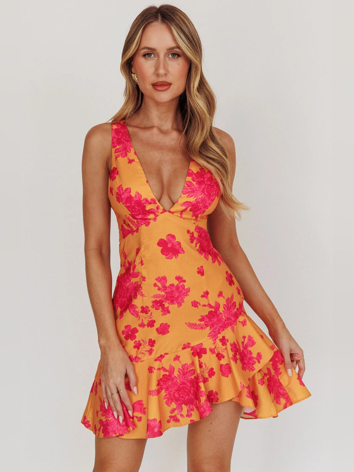 Orange floral mini dress with sleeveless V-neck bodice and tiered ruffle hem