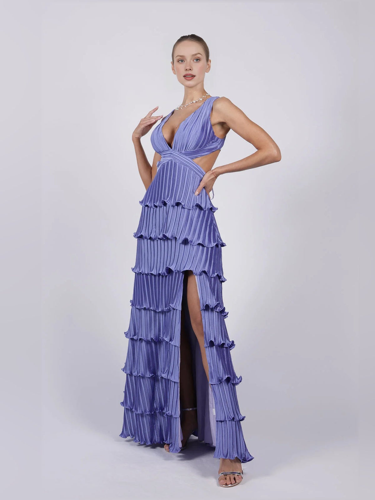 Purple v-neck pleated tiered formal dress with thigh slit, sleeveless, floor-length.