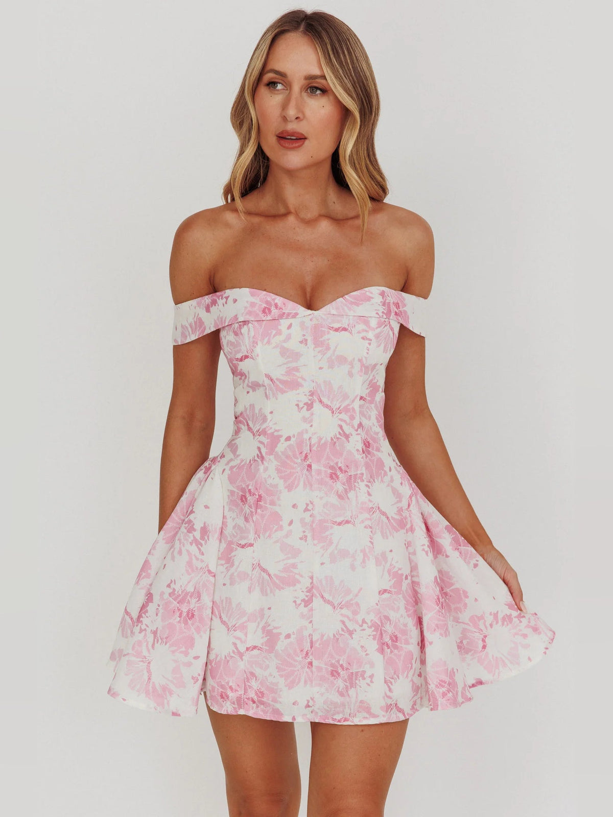 Pink floral off-shoulder mini dress with fitted bodice and flared skirt