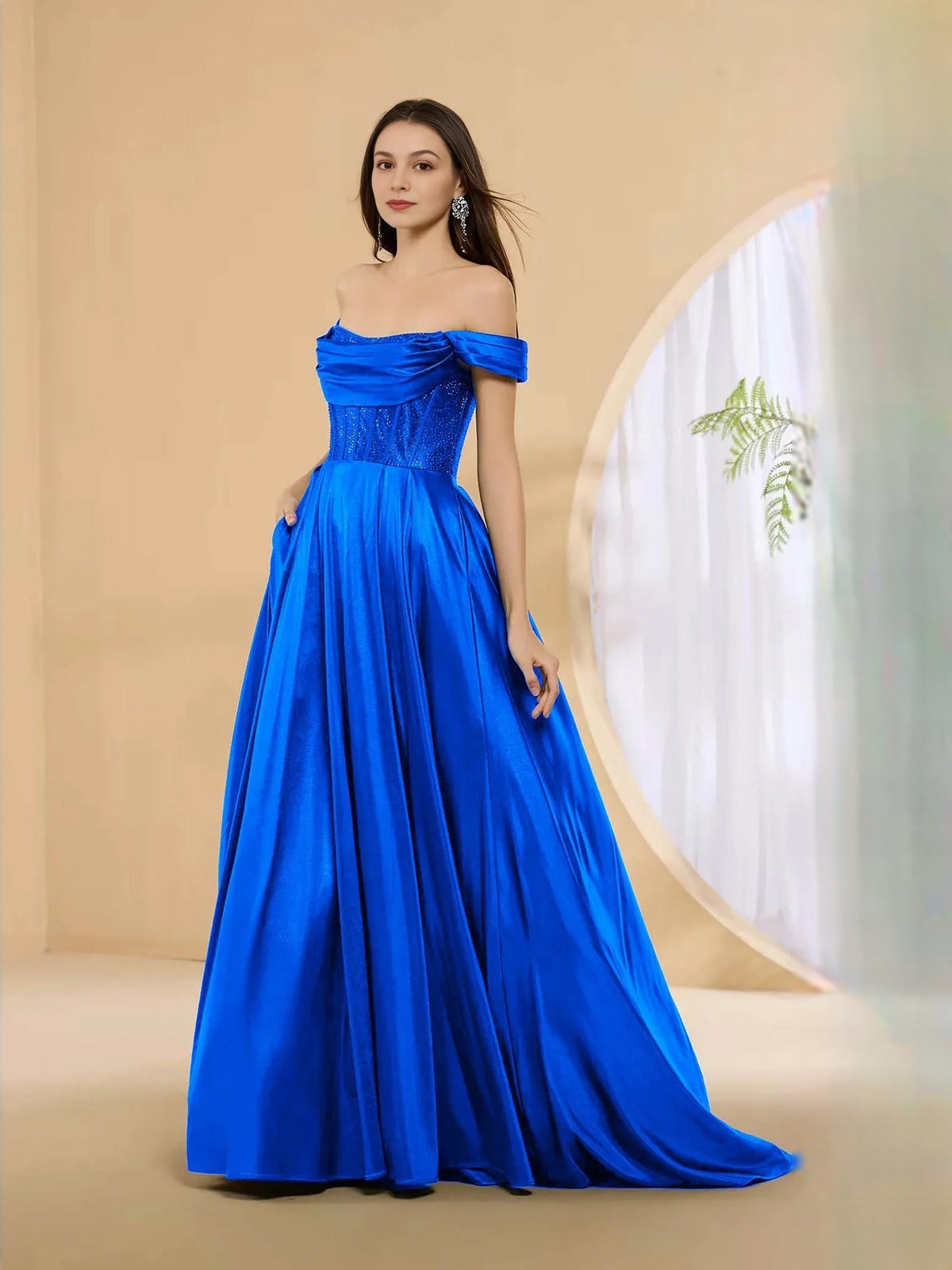 Off-shoulder corset formal dress in cobalt blue with pleated floor-length skirt