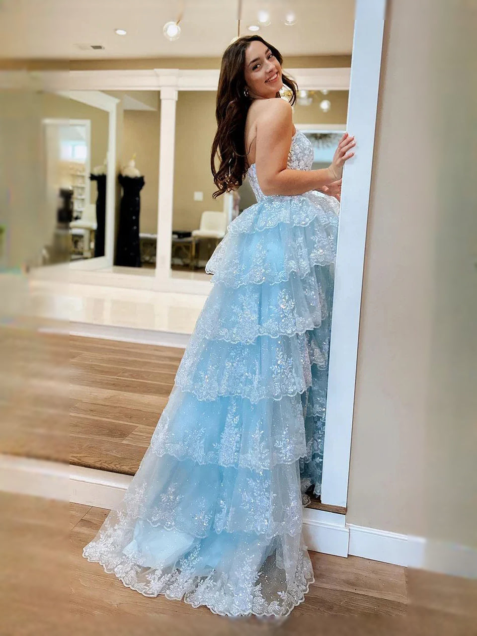 Light blue strapless tiered tulle prom dress with floral ruffled layers and high-low hem